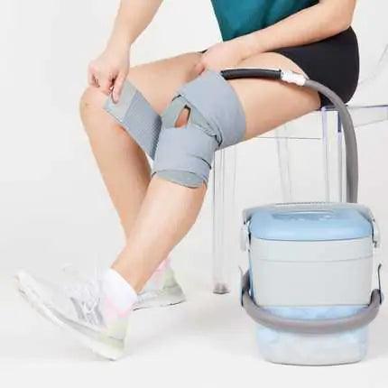 Person wearing DonJoy Iceman Classic3 cold therapy knee wrap connected to supply cold therapy device