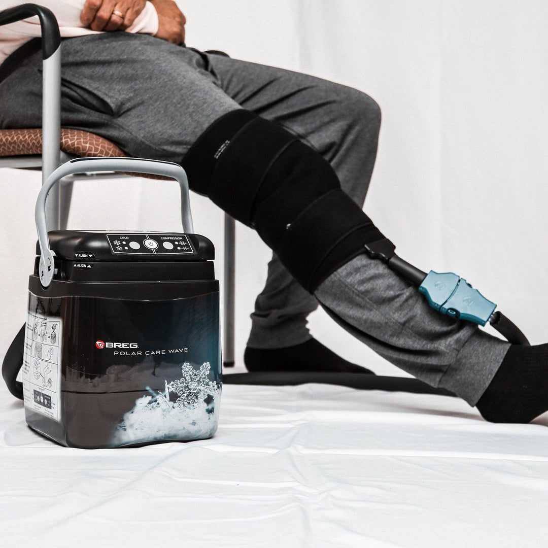 Breg Polar Care Wave cold therapy device providing compression and cold treatment on a seated person's leg